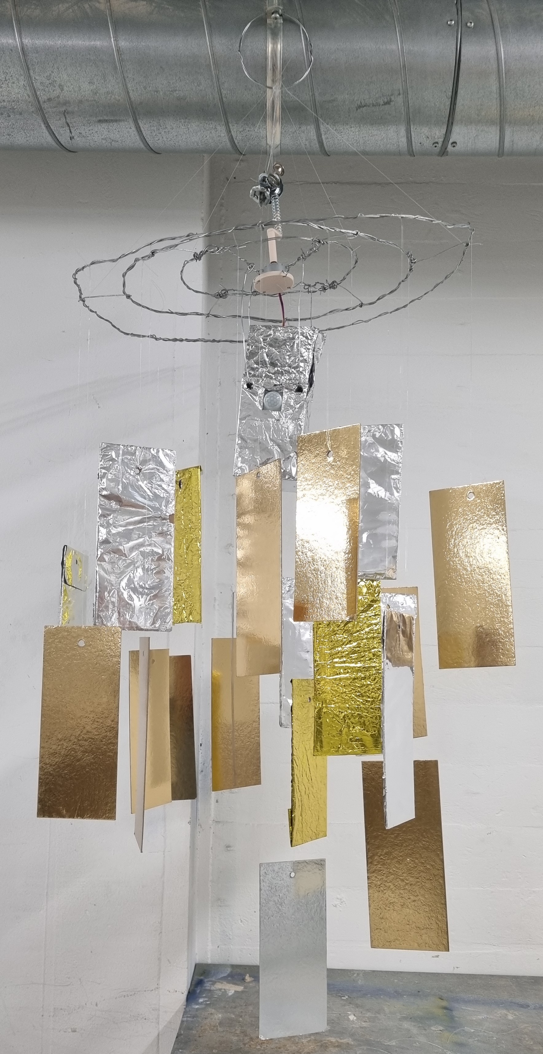 Passing Tales — Chandelier like sculpture with metallic panels
