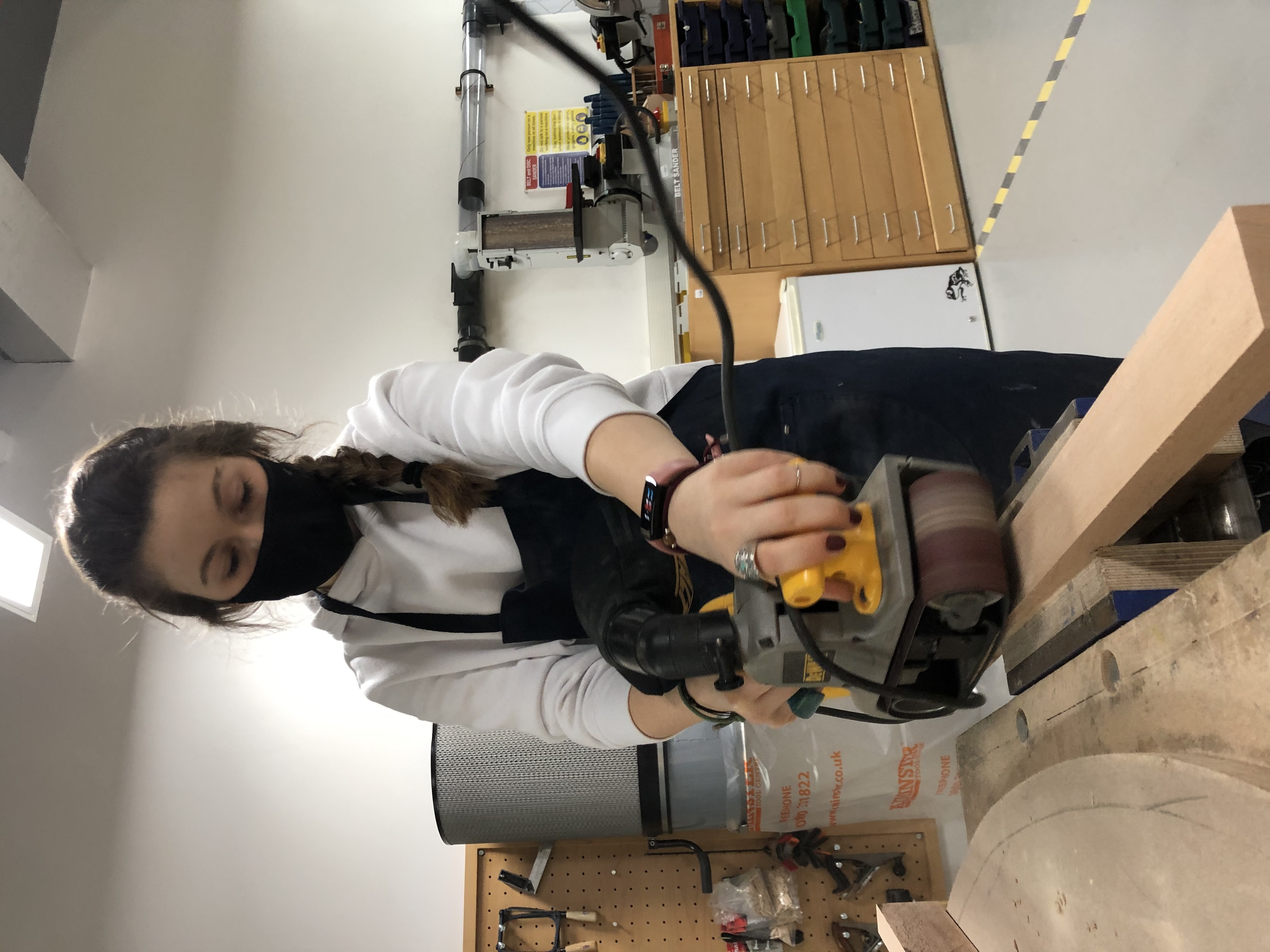 PawHaven — Sanding wood planks with an electric sander