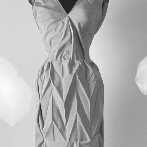 PAUX — V-neck dress with architectural origami-like pleats